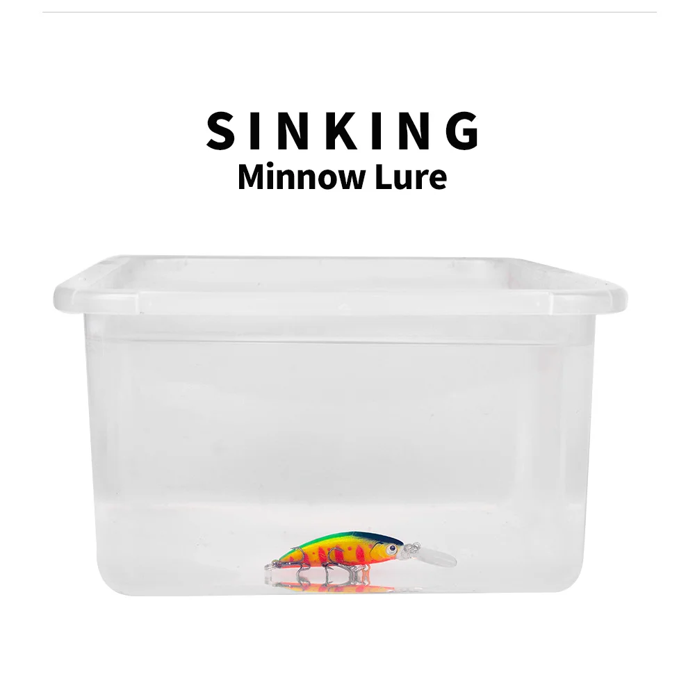 Blue sinking minnow lure partially submerged in a transparent water container to show sinking action