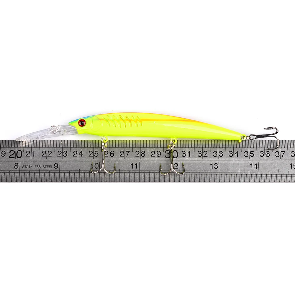 Yellow-green minnow lure placed on a measuring ruler showing 125mm length