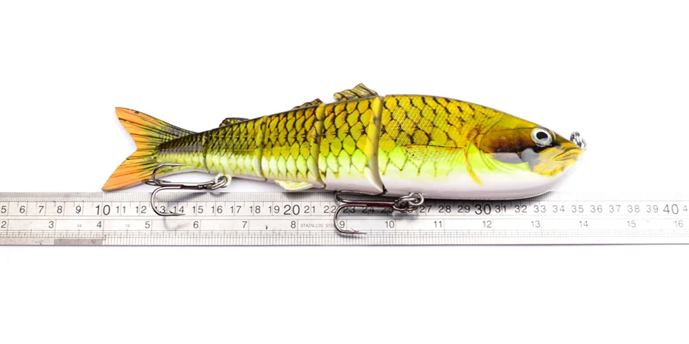 Close-up of lure beside ruler showing length measurement (11 cm)